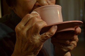 Fototapeta na wymiar Close up of elderly woman drinking tea