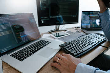 Programmer working On Computer In IT Office Typing Data Coding in software and checking code on...