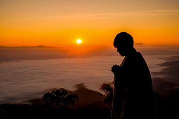 Silhouette of christian man hand praying,spirituality and religion,man praying to god.