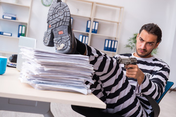 Young employee feeling like prisoner at work