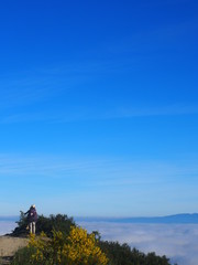 Amazing sea of clouds with Pilgrim on the road to Santiago de Compostela, Camino de Santiago, Way of St. James, Journey from Foncebadon to Ponferrada, French way, Spain