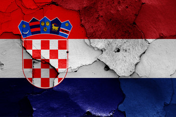 flags of Croatia and Netherlands painted on cracked wall