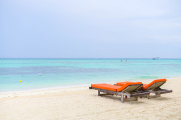 Beautiful beach. Chairs on the sandy beach near the sea. Summer holiday and vacation concept for tourism. 