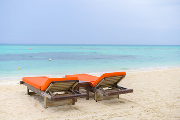 Beautiful beach. Chairs on the sandy beach near the sea. Summer holiday and vacation concept for tourism. 
