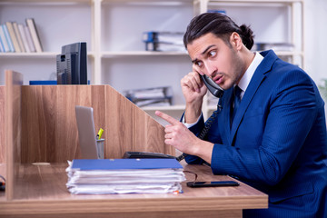 Young handsome businessman working in the office