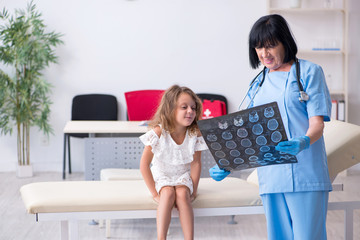 Little girl visiting old female doctor