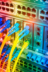 Fiber Optic cables connected to an optic ports and Network cables connected to ethernet ports