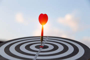 Red dart target arrow hitting on bullseye with,Target marketing and business success concept