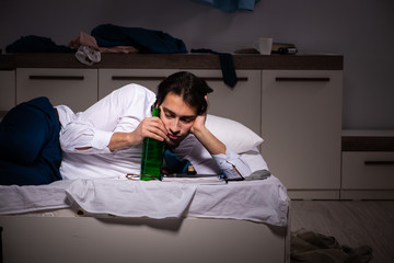 Young employee working at home after night shift