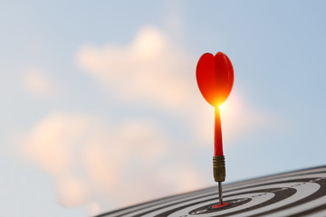 Red dart target arrow hitting on bullseye with,Target marketing and business success concept