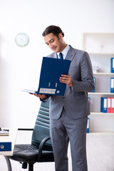 Young male accountant working in the office