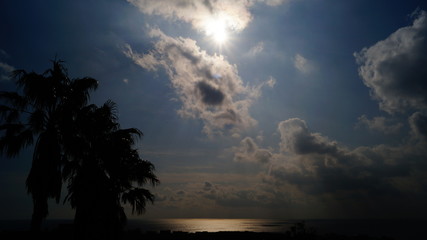 Fototapeta na wymiar The Sun and Clouds at the Beach