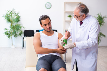 Fototapeta premium Young male patient visiting experienced doctor