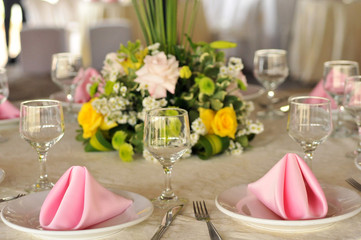 Table setting with glasses, plates, napkins and food