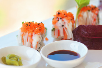 Close-up view of Uramaki sushi with wasabi and soy sauce