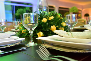 Table setting with glasses, plates, napkins and food