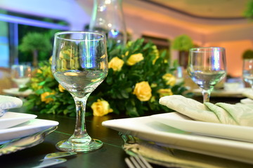 Table setting with glasses, plates, napkins and food