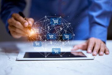 Business using tablet,with shopping cart icon,sale volume increase make business growth and...
