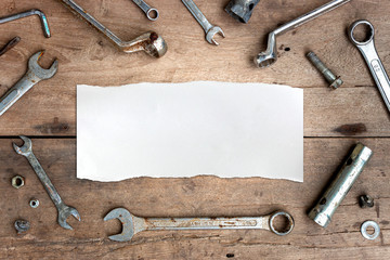 old tools and white paper on wooden floor background