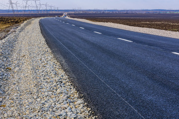 New asphalt road with the white dividing strip