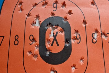 Gun range target with bullet holes