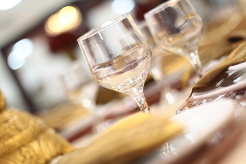 Table setting with glasses, plates, napkins and food