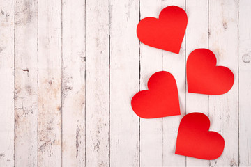 Flatlay composition with hearts on a wooden background