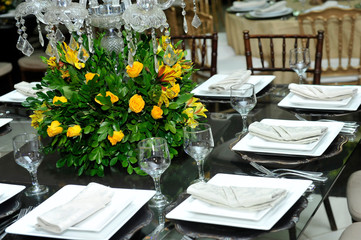 A luxurious bouquet of fresh flowers in a crystal vase on the holiday table and an elegant portion in the restaurant.
