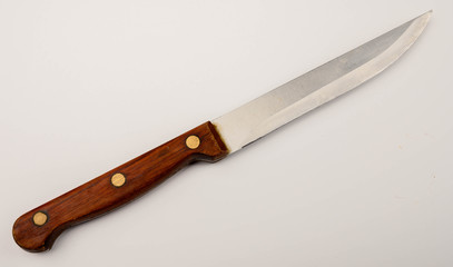 Old vintage knife with wooden handle on white background. Close up.