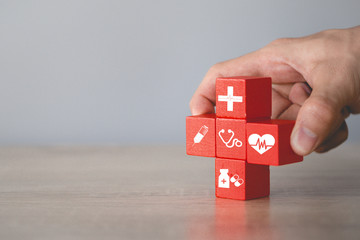 Health Insurance Concept,hand arranging wood block stacking with icon healthcare medical.