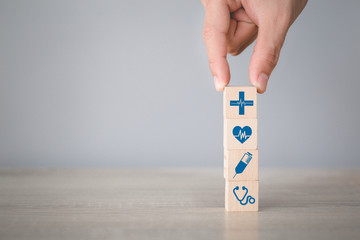 Health Insurance Concept,hand arranging wood block stacking with icon healthcare medical.