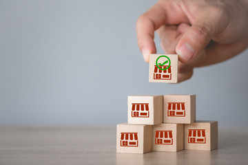 Franchise business concept,hand choose wood blog with franchise marketing.