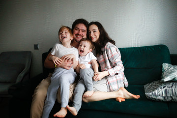 Authentic family with two children on sofa