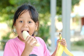 Children enjoy and eating bananas. and smiling