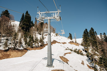 Cableway Ski Lifts. Cable car in the mountains. Trees in the mountains near the cable car.