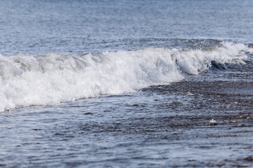 Waves on the beach. A surge of water ashore.