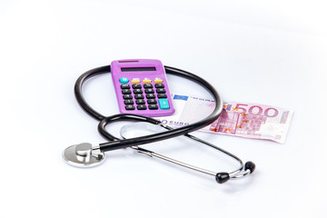 health care concept with calculator, money and stethoscope on white background
