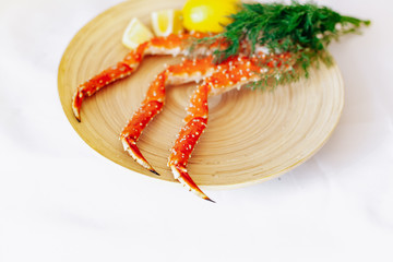 Crab, lemon and dill on a plate on a white background.