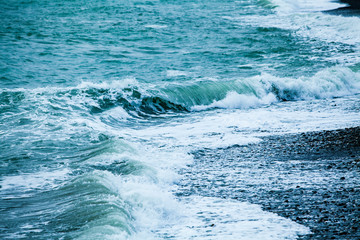 Fototapeta na wymiar waves on the surface of the blue sea