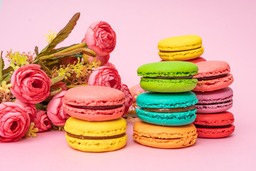 tasty colorful macarons on pink background