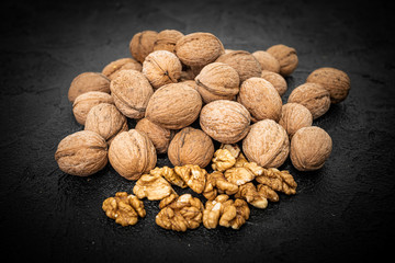 Walnuts on black background. Group walnuts on Healthy organic food concept.