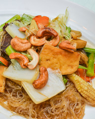 Vegetarian food stir-fried vermicelli in a white plate on the table