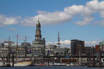 Fototapeta na wymiar Hamburg, Germany - September 3, 2014: the Hamburg city skyline with the church Michel and the TV tower with ships on the Elbe river in front
