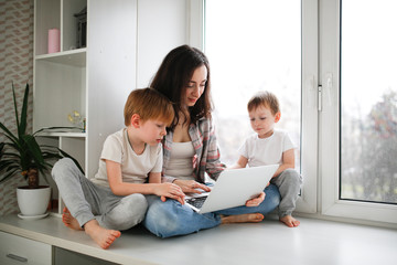 mother with children with laptop online shopping