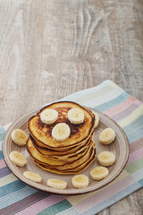 Pancakes with bananas almond and caramel sauce. selective focus.