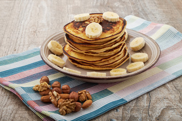 Pancakes with bananas almond and caramel sauce. selective focus.