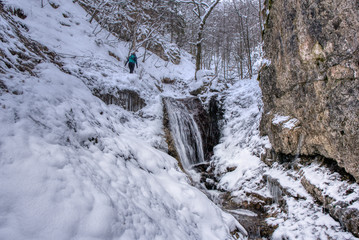 Fototapeta na wymiar Winter landscape in the valley of mountains with a beautiful stream and snow around, Slovakia Mala Fatra, Janosik Holes