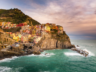 Manarola, Cinque Terre (Five Lands), Liguria, Italy: Beautiful sunset view of a village perched on a hill, typical colorful houses. The Cinque Terre National Park is a UNESCO World Heritage Site