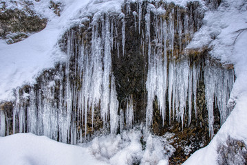 Large stalactites with ice in the mountains on a rock , slovakia mala fatraLarge stalactites with ice in the mountains on a rock , slovakia mala fatra