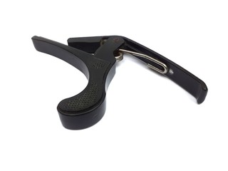 Old black colour guitar capo isolated on white background